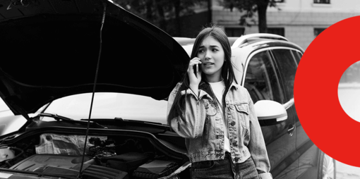 Capa de artigo sobre a Allianz Seguros - DOK Despachante; Descrição: jovem mulher branca fala ao telefone encostada em carro com o capô aberto. Imagem em preto e branco.